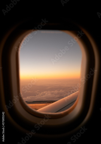 view from the window of an airplane in flight at sunset