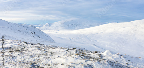 Photography Scenic view of the snow covered landscape of the Dovre mountains in Norway at wi