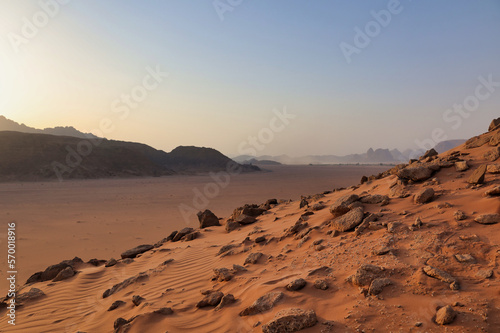 roks and red sand in wadi rum desert at sunset
