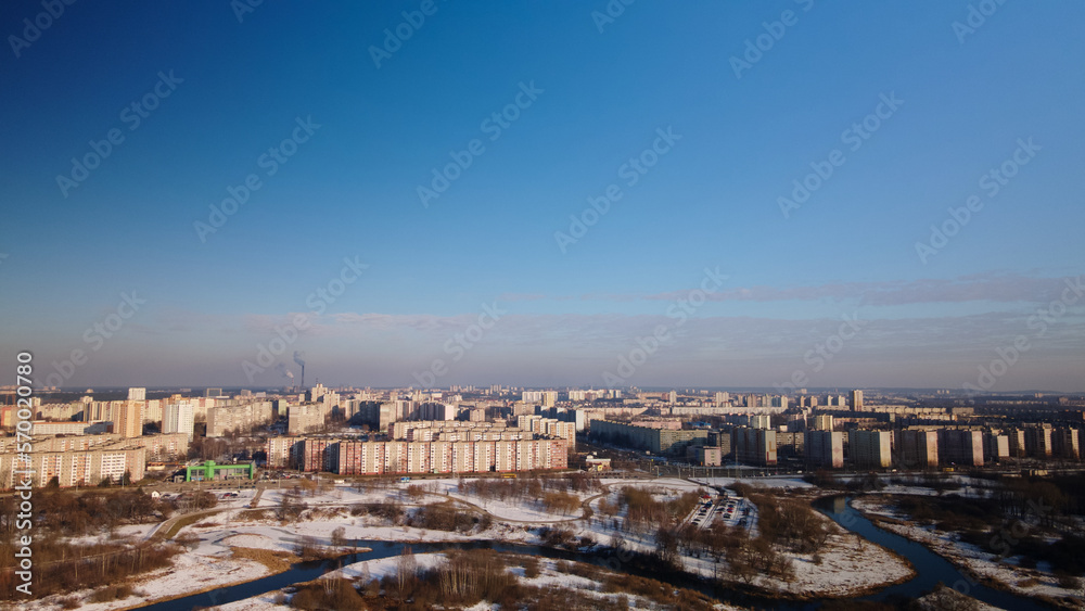 City park in winter. Snow lies on the ground. A meandering river flows. Aerial photography.