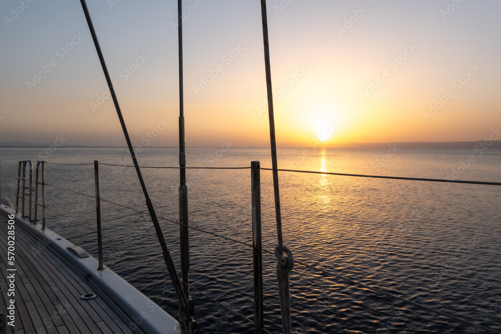 Railing and struts of sailing yacht at sunset
