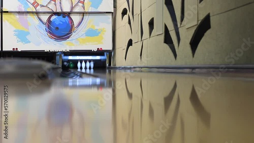 Man's hand throwing a bowling ball for skittles