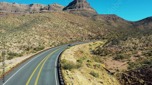 Aerial view of a sport car driving on the road at Zabriskie point, Death Valley, United States.