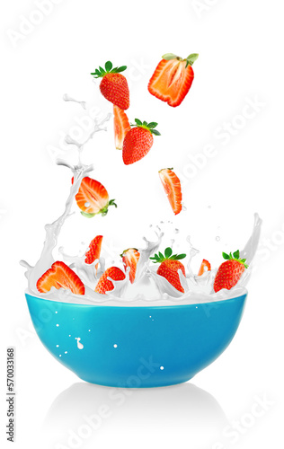 Strawberries falling into a fresh bowl of cream. Healthy Breakfast, fresh berries and splashing milk. Healthy breakfast concept. vegetarian food