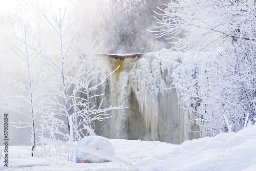 Frozen small mountain waterfall close up. Frozen Jagala Falls, Estonia. small river waterfall frozen in winter. photo