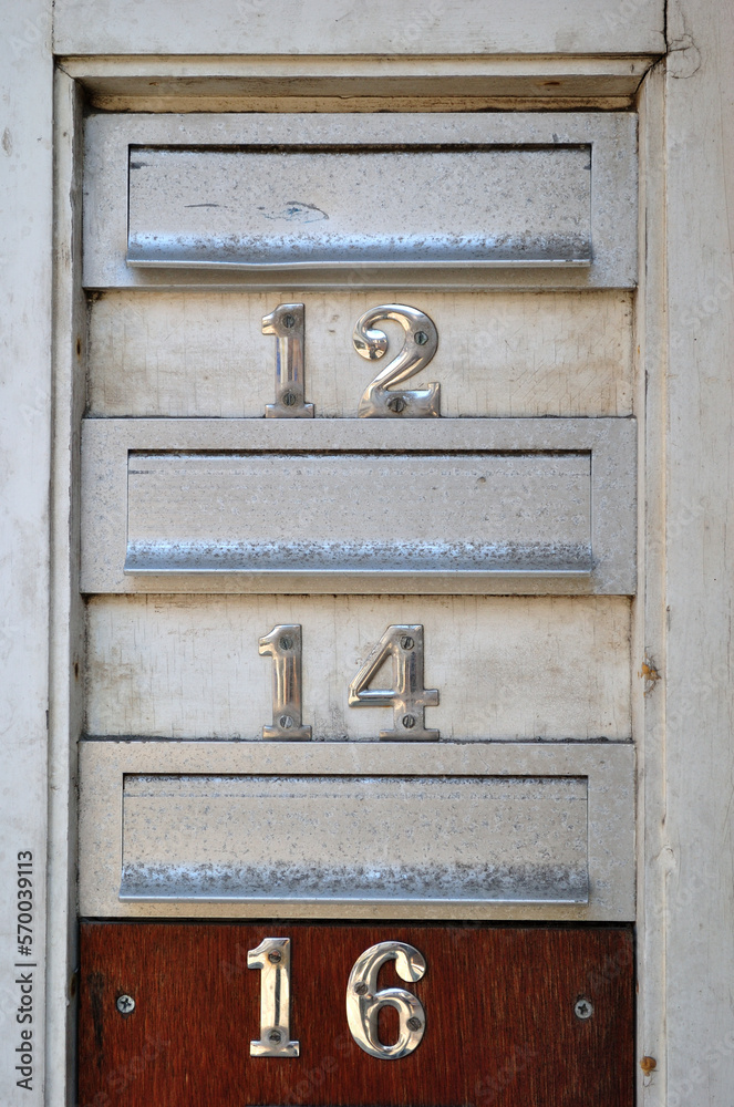 Close Up of Metal Mail Boxes with Numbers  '12-14 and 16' 