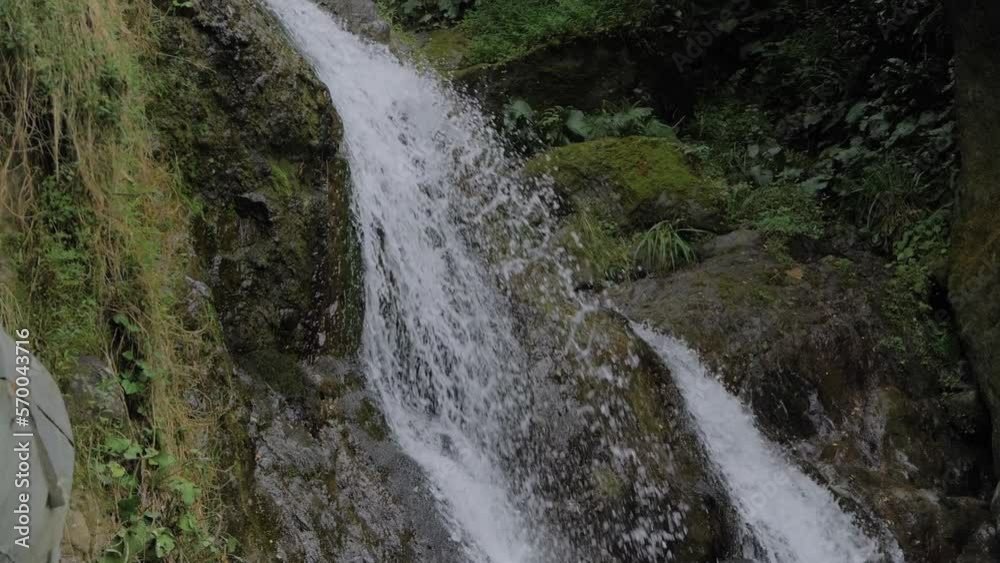 Slow motion: river or stream of water flowing and falling down - Andrew the Apostle waterfall in the mountain in Batumi, Georgia. Nature, landscape and environment concept Slow motion: river or stream of water flowing and falling down - Andrew the Apostle waterfall in the mountain in Batumi, Georgia. Nature, landscape and environment concept