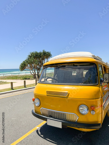 Retro van on asphalt road of coastline