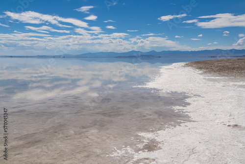 Panoramic view of beautiful mountains reflecting in lake of Bonneville Salt Flats, Wendover, Western Utah, USA, America. Looking at summits of Silver Island Mountain range. West of Great Salt Lake photo