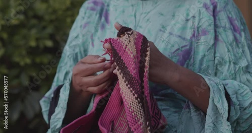  Detail of a Colombian indigenous woman from La Guajira weaving a handmade bag 