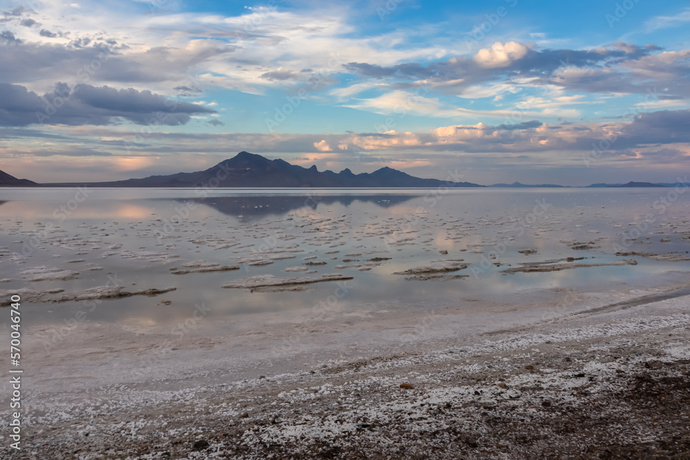 Scenic view of beautiful mountains reflecting in lake of Bonneville Salt Flats at sunset, Wendover, Western Utah, USA, America. Looking at summits of Silver Island Mountain range. Romantic atmosphere Scenic view of beautiful mountains reflecting in lake of Bonneville Salt Flats at sunset, Wendover, Western Utah, USA, America. Looking at summits of Silver Island Mountain range. Romantic atmosphere