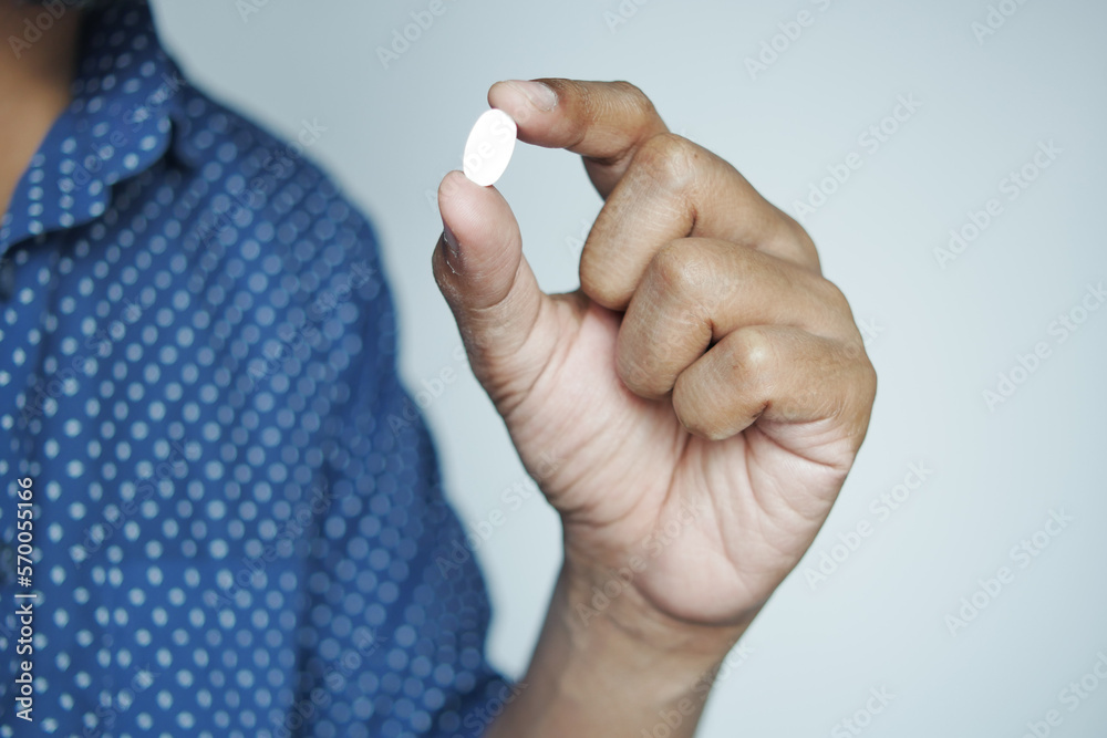 Fototapeta premium Close up of man hand holding pills with copy space 
