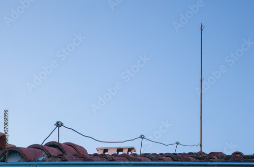 Traditional lighting rod over tile roof photo