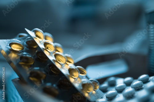 Pile of yellow pills - Vitamin D - Fish oil with Omega 3