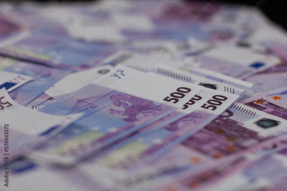 Background illuminated euro banknotes lie in the dark. Euro banknotes in large numbers create a great backdrop. Finance and euro concept. Background illuminated euro banknotes lie in the dark. Euro banknotes in large numbers create a great backdrop. Finance and euro concept.