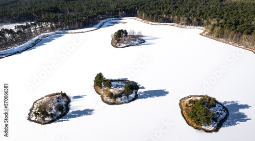 Islands on a snow-covered lake. Islands on a frozen lake. 