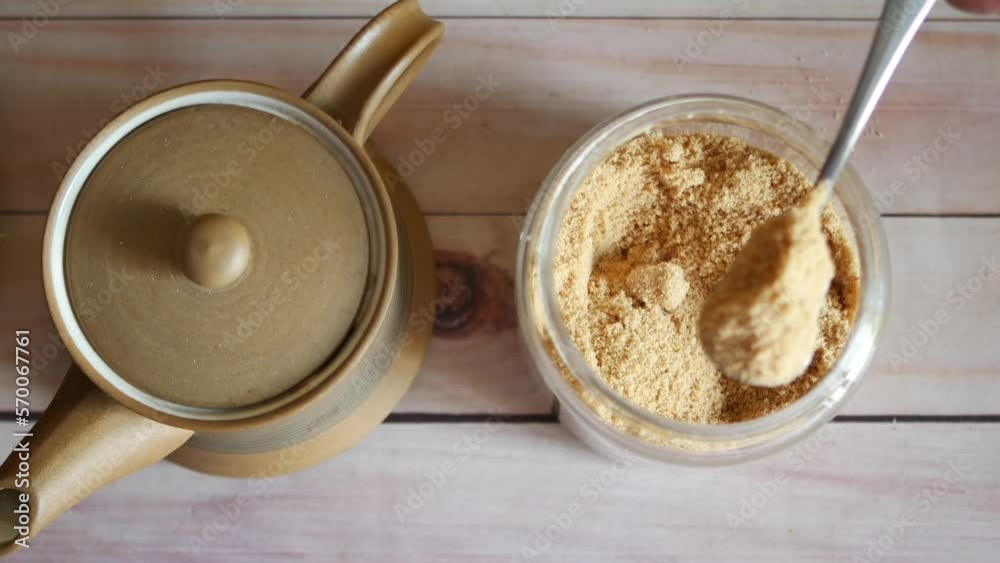 spoon pick coconut sugar from a container on table spoon pick coconut sugar from a container on table