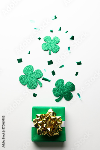 Image of green clover, green present and copy space on white background