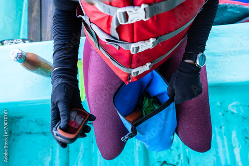 Marine biologist holding a mobile on a boat