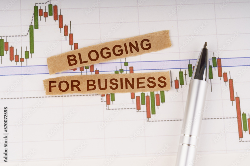 On the chart of business quotes lies a pen and torn paper with the inscription - Blogging for Business On the chart of business quotes lies a pen and torn paper with the inscription - Blogging for Business