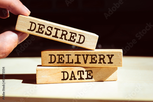 Wooden blocks with words 'DESIRED DELIVERY DATE'.