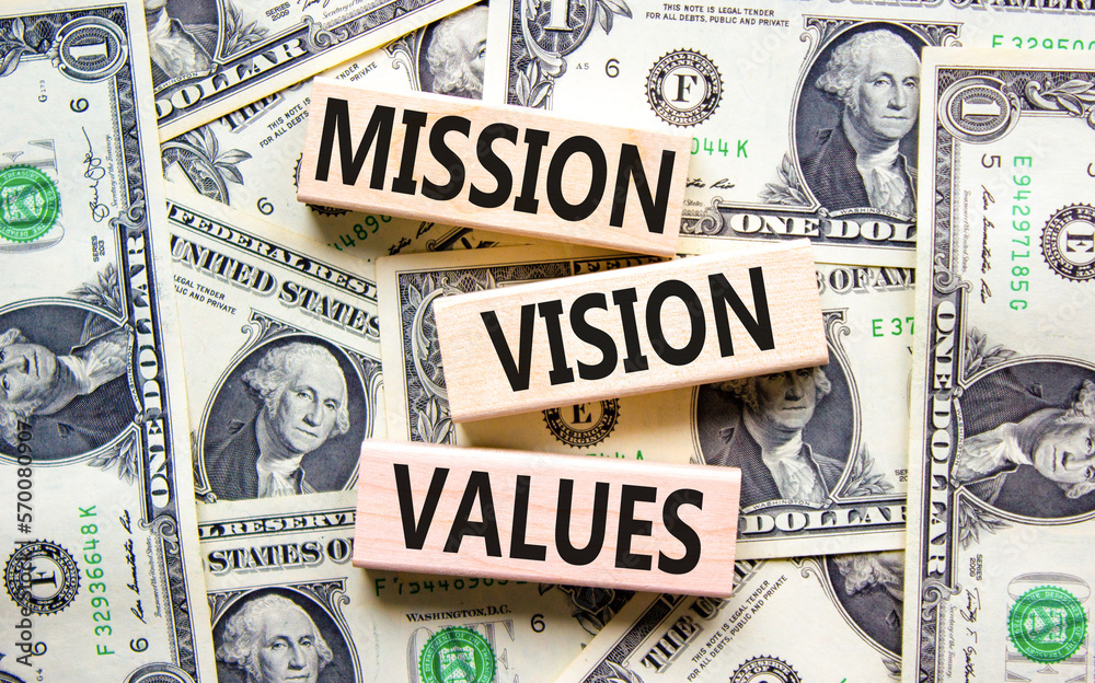 Mission vision values symbol. Concept words Mission Vision Values on wooden blocks on a beautiful background from dollar bills. Business mission vision values concept. Copy space.