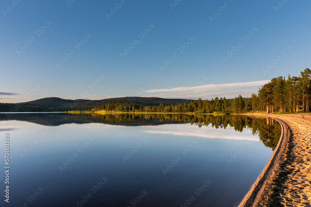 Peaceful landscape of Lake Inari with the midnight sun in Lapland, Finland