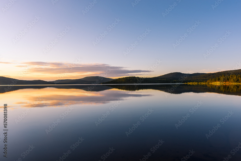 Peaceful landscape of Lake Inari with the midnight sun in Lapland, Finland