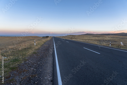 Asphalt road going through the fields