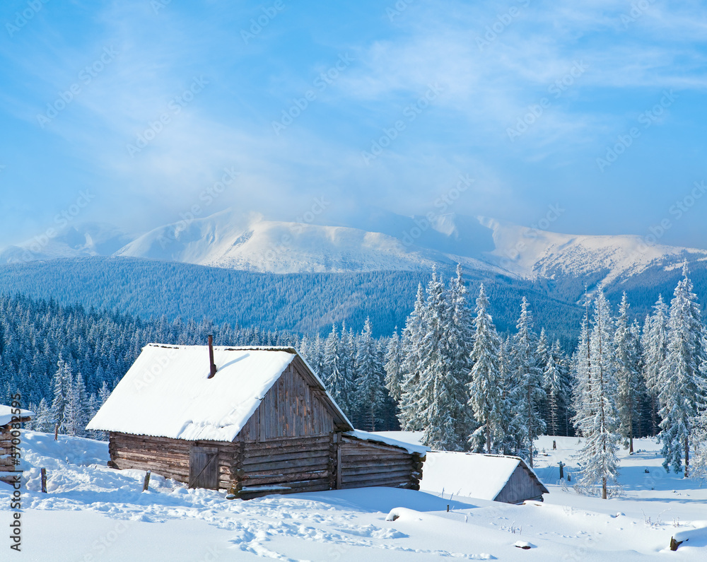 Winter calm mountain landscape with shed and mount ridge behind (Kukol Mount, Carpathian Mountains, Ukraine)