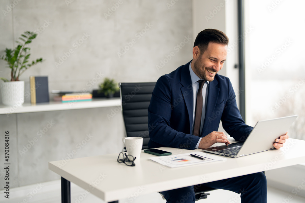 Handsome well dressed businessman working at his office, businessman working on a project Handsome well dressed businessman working at his office, businessman working on a project