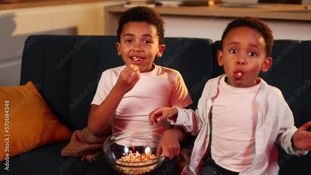 Camera view of cute little african american boys brothers eating