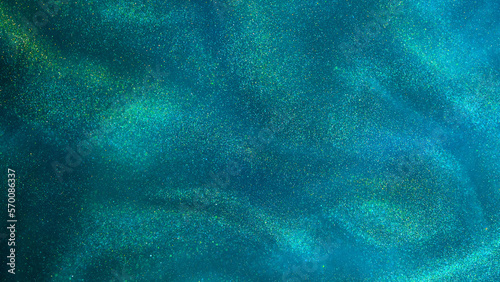 Various stains and overflows of gold particles in green fluid with blue tints. Golden particles dust and smooth defocused background. Liquid iridescent shiny backdrop with depth of field.