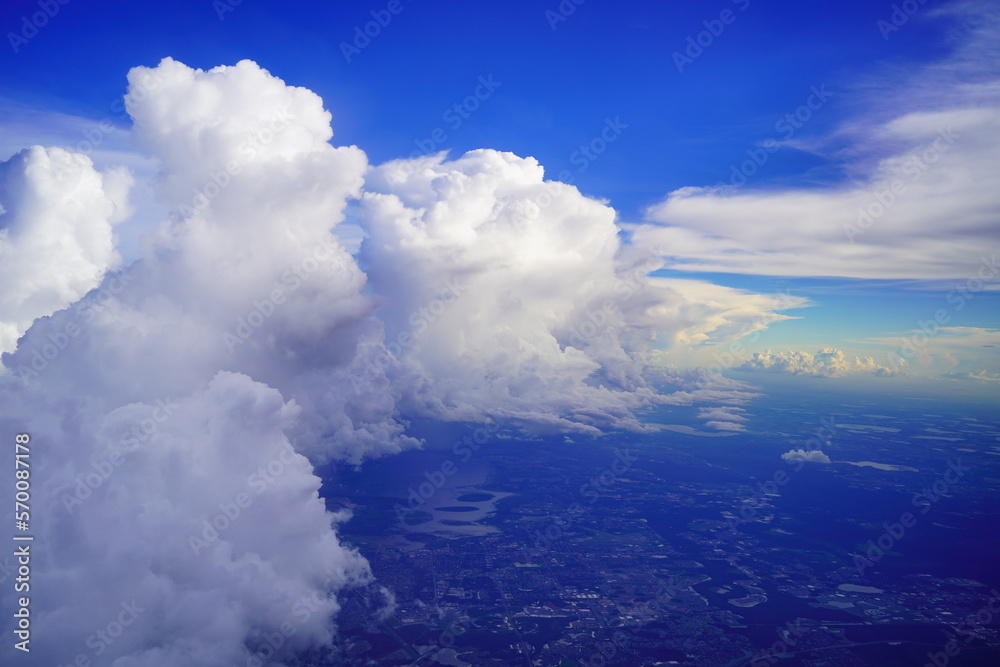 Aerial view of a large and fluffy Cumulonimbus Thunderstorm Cloud seen from airplane	
