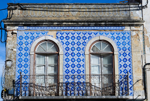 Azulejos in Portugal, detail on a typical house, blue color. Portugese balcony. photo