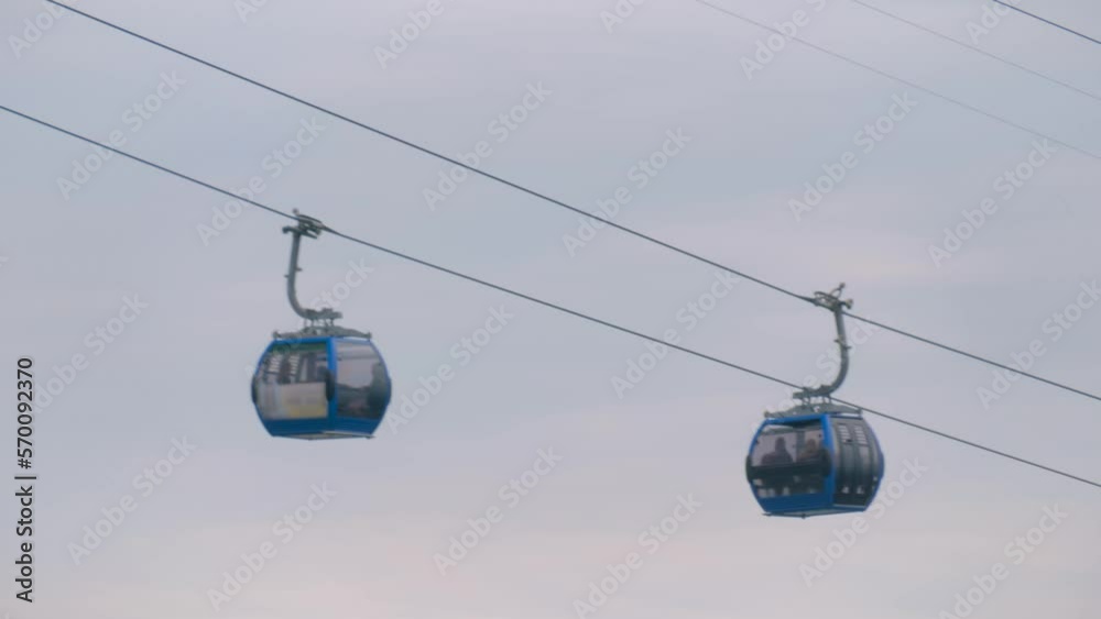 Ropeway, cable car cabins are moving against gray sky in Batumi, Georgia - aerial rope transit, gondola lift. Tourism, cableway, sightseeing and public transportation concept Ropeway, cable car cabins are moving against gray sky in Batumi, Georgia - aerial rope transit, gondola lift. Tourism, cableway, sightseeing and public transportation concept