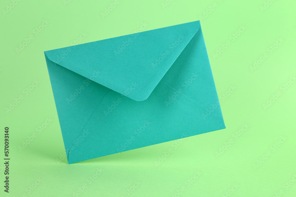Paper envelope on green background Paper envelope on green background