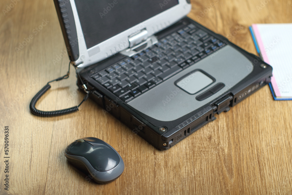 computer mouse next to the laptop computer mouse next to the laptop