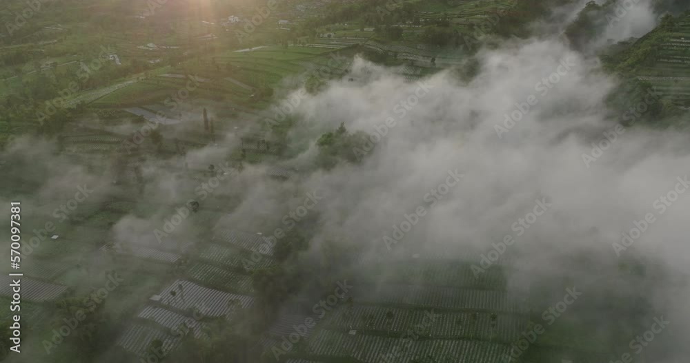 Aerial Panning Shot Of Clouds Over Rice Paddies On Hill During Sunset - Java, Indonesia Aerial Panning Shot Of Clouds Over Rice Paddies On Hill During Sunset - Java, Indonesia