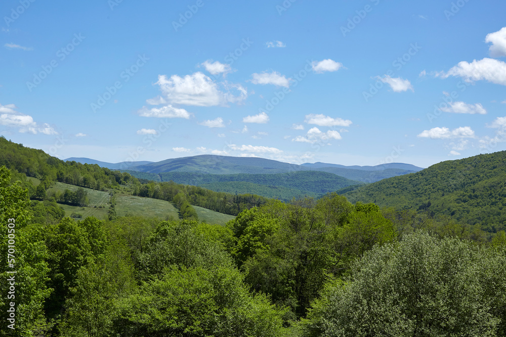 Landscape photograph with green rolling hills and blue sky. Summer scene. Landscape photograph with green rolling hills and blue sky. Summer scene.