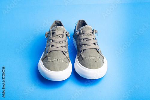 sneaker on blue background. Fashionable stylish sports casual shoes. Creative minimalistic layout with footwear. Mock up for design advertising for shoe store