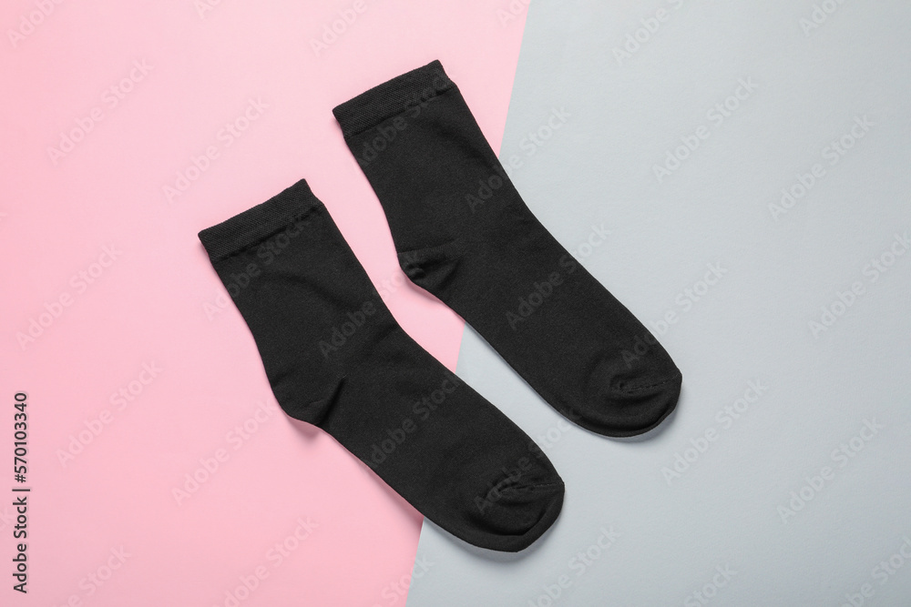 Pair of black socks on color background, flat lay Pair of black socks on color background, flat lay