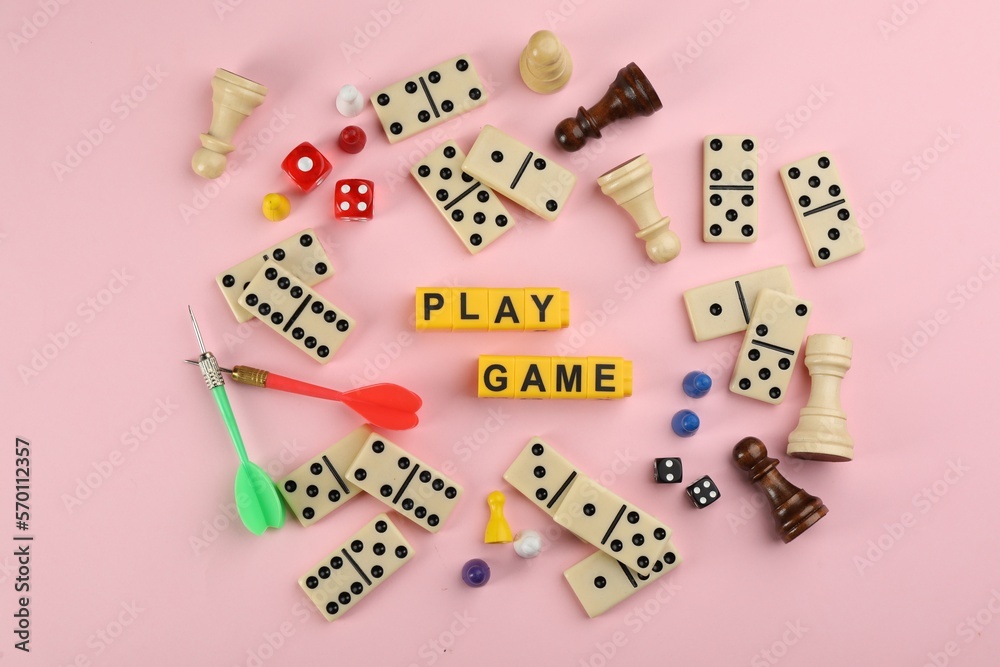 Flat lay composition of blocks with words Play Game on pink background
