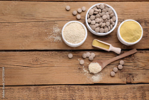 Flat lay composition with different types of brewer`s yeast on wooden table. Space for text photo