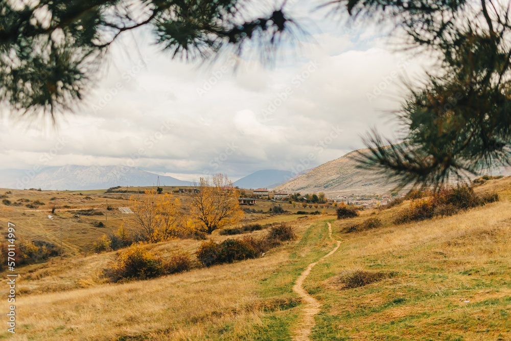 Obraz premium Landscape view of hills and mountain and far city of Korce, Albania