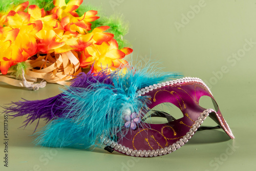 Fototapeta Naklejka Na Ścianę i Meble -  Venetian carnival mask with feathers, and typical elements in the background