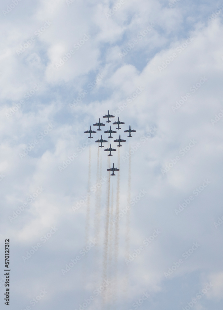 Airplanes flying in formation in a flight show. Blue sky in the background. Air Show, Sky Aerobatic Team, Plane acrobatics, Planes. Airplanes flying in formation in a flight show. Blue sky in the background. Air Show, Sky Aerobatic Team, Plane acrobatics, Planes.