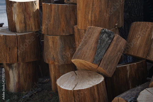 Small pieces of sawn wood are stacked on top of each other in a city park.
