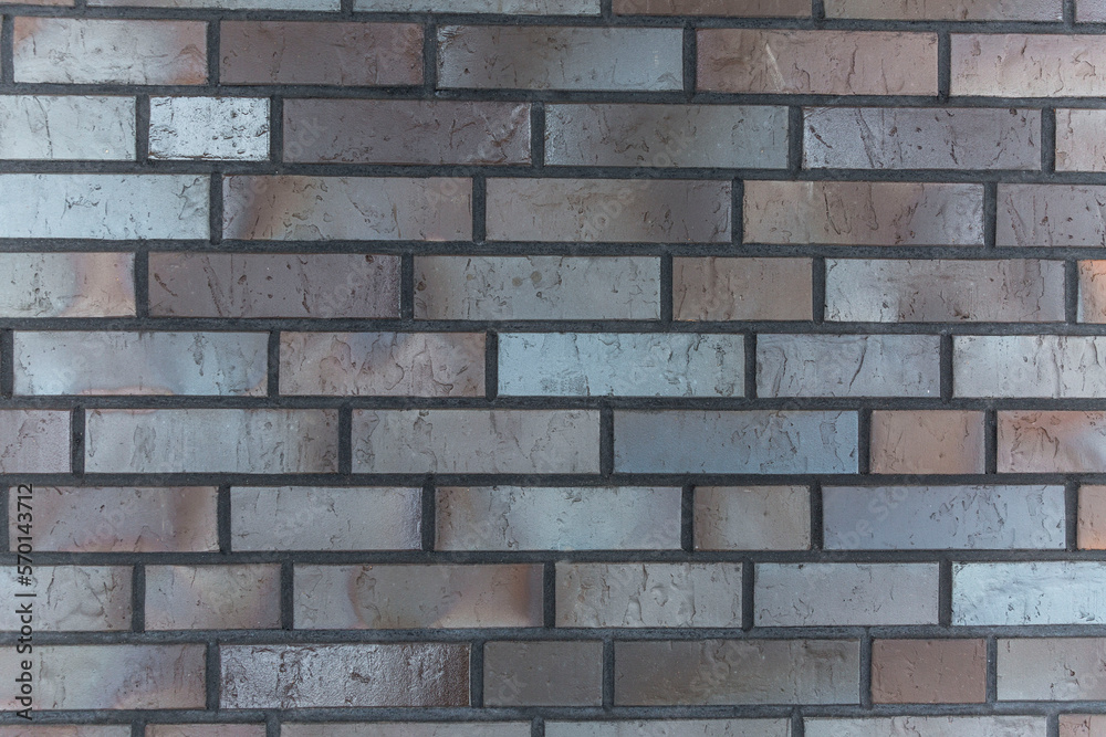 Wall made of baked decorative bricks. Construction and repair. Front view. Background. Space for text. Wall made of baked decorative bricks. Construction and repair. Front view. Background. Space for text.