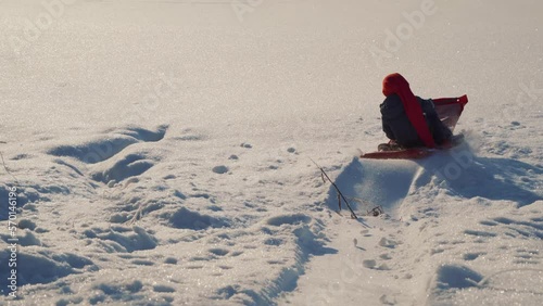 A little boy plays sleigh on a Christmas day in winter in Norway photo